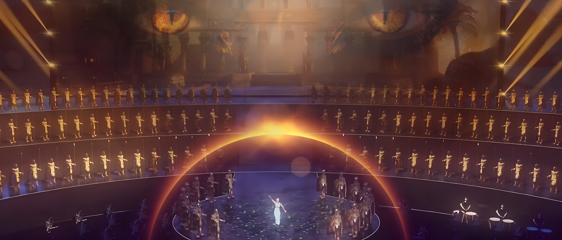 an image of Cleopatra surrounded by her royal entourage on a modern theatre set.